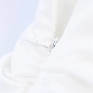 Close-up of white backless maxi dress showing the seamless invisible zipper detail