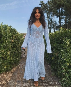 Detail of light blue crochet maxi dress featuring intricate hollow-out patterns and V-neck