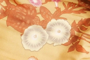 Macro shot of floral print fabric detail for summer dress with soft pastel flowers