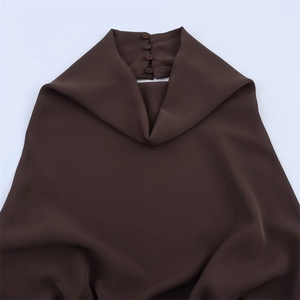 Detail of high neck chocolate brown dress with back buttons and silky draped fabric texture