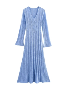 Detail of light blue knit dress featuring V-neckline and intricate floral crochet pattern
