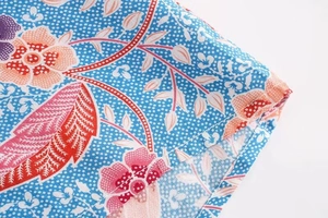 Detailed view of the sky blue floral print and sewing quality on this cotton shirt