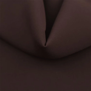Detailed macro view of the dark brown knitted elastic fabric with fine ribbed texture