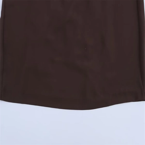 Close-up of the dark brown high-quality smooth fabric hem for a backless long maxi dress