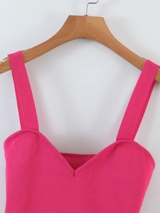 Detail of bright pink knitted camisole with ribbed texture and V-neck design