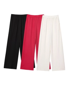 Detailed macro view of textured waffle knit wide leg pants in black, rose, and cream