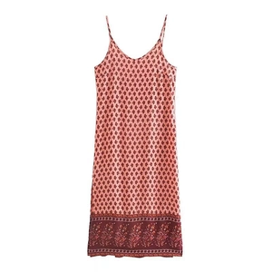 Detail showing red floral patterns and ethnic border print on a pink maxi sundress
