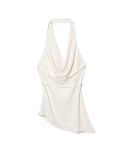 Detail view of white halter top with draped neck, textured fabric, and asymmetric hemline