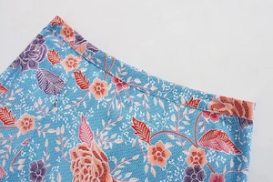 Detail view of floral print skirt featuring batik pattern and fine stitching seams