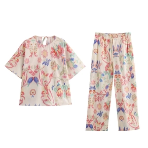 Detailed flat lay of bohemian floral print short sleeve top and matching trousers set
