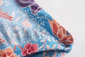 Detail of blue floral print skirt showing high-quality stitching and fabric texture