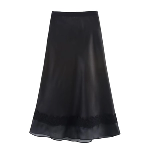Detailed macro view of the black satin midi skirt with lace hem and sheer chiffon trim