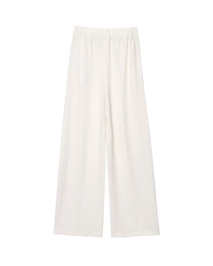 Detail of white high-waist wide-leg trousers featuring textured seersucker fabric