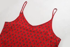Detail of red floral camisole top with V-neck and ruffled thin straps for women