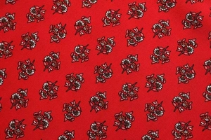 Detail shot of the red floral print fabric with delicate vintage-style small blossoms