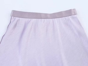 Detail view of the high-waisted elastic band on this lavender satin organza skirt