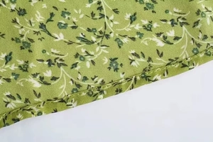 Detail of the green floral fabric showing precision stitching and twill texture