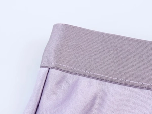Detail of lavender satin organza skirt showing high elastic waistband and precision stitching