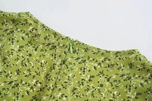 Detail view of the green floral dress featuring a neat back invisible zipper closure