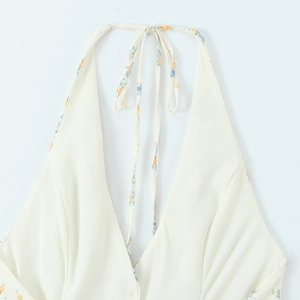 Close-up of floral print halter neckline with tie-back detail on poplin dress