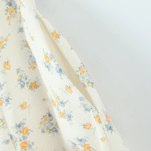 Detail showing the floral poplin dress with hidden side pocket and high-quality stitching