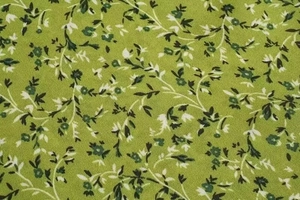 Detailed macro shot of the green floral fabric texture with elegant botanical print