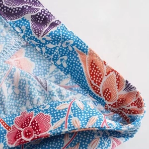 Floral print skirt in cobalt blue with intricate pink blossoms and serged edge detail