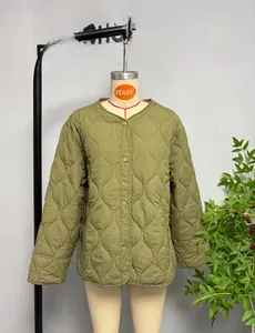 Detail of army green quilted jacket showing onion patterns and snap button closure