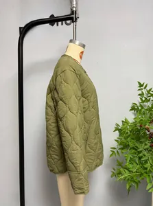 Detailed close-up of army green quilted jacket with onion stitch patterns and side slits
