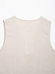 Detailed close-up of oatmeal linen vest showing refined embroidery and natural fabric texture