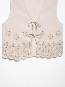 Detail of floral embroidery and scalloped edge on beige linen blend vest for women