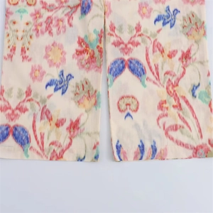 Detail of bohemian floral pattern on breathable cream linen fabric for women pants