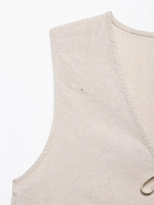 Close-up of linen-blend vest featuring V-neckline and intricate fabric texture
