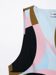 Close-up of geometric abstract print on sleeveless top with colorful pattern and logo