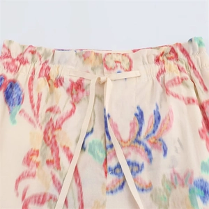 Detail of elastic drawstring waistband on colorful tropical floral print summer trousers