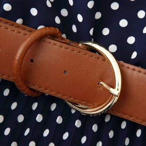 Caramel brown leather belt with gold metal buckle on navy blue polka dot midi dress
