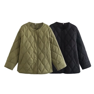 Detail of army green and black quilted jackets with snap buttons and wavy stitching