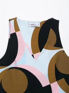 Close-up of V-neck top with geometric abstract print and brand neck label detail