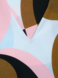 Detailed macro view of V-neckline and modern abstract geometric print fabric texture