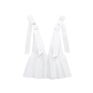 Detailed close-up of white poplin top with oversized bow straps and ruffled hem design