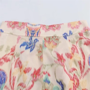 Detail of colorful bohemian floral print fabric and waist stitching on trousers