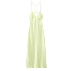Detail of cross-back straps and silky satin texture on light yellow slip dress
