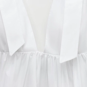 White sleeveless poplin top with V-neckline and elegant pleated waist detail