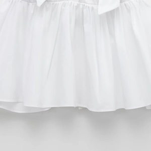 Elegant white poplin blouse featuring refined pleats and a drawstring bow detail