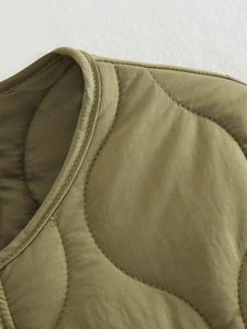 Detail of olive green onion-quilted cotton vest showing round neckline and fine stitching