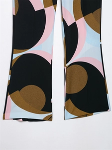Detail of wide leg pants hem featuring retro geometric print in black, pink, and blue