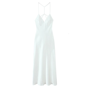 Detailed view of the back of white satin maxi dress featuring intricate crisscross straps