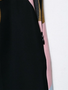 Detail view of smooth invisible zipper on multi-color geometric print trousers