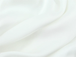 Detailed close-up showing the smooth satin texture and fine fabric of this white dress