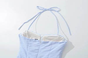 Detail of blue striped halter dress featuring neck tie bow and invisible back zipper